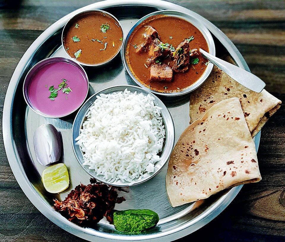 A complete Rasoi Express vegetarian thali with rice, roti, sabzi, dal, salad and pickle